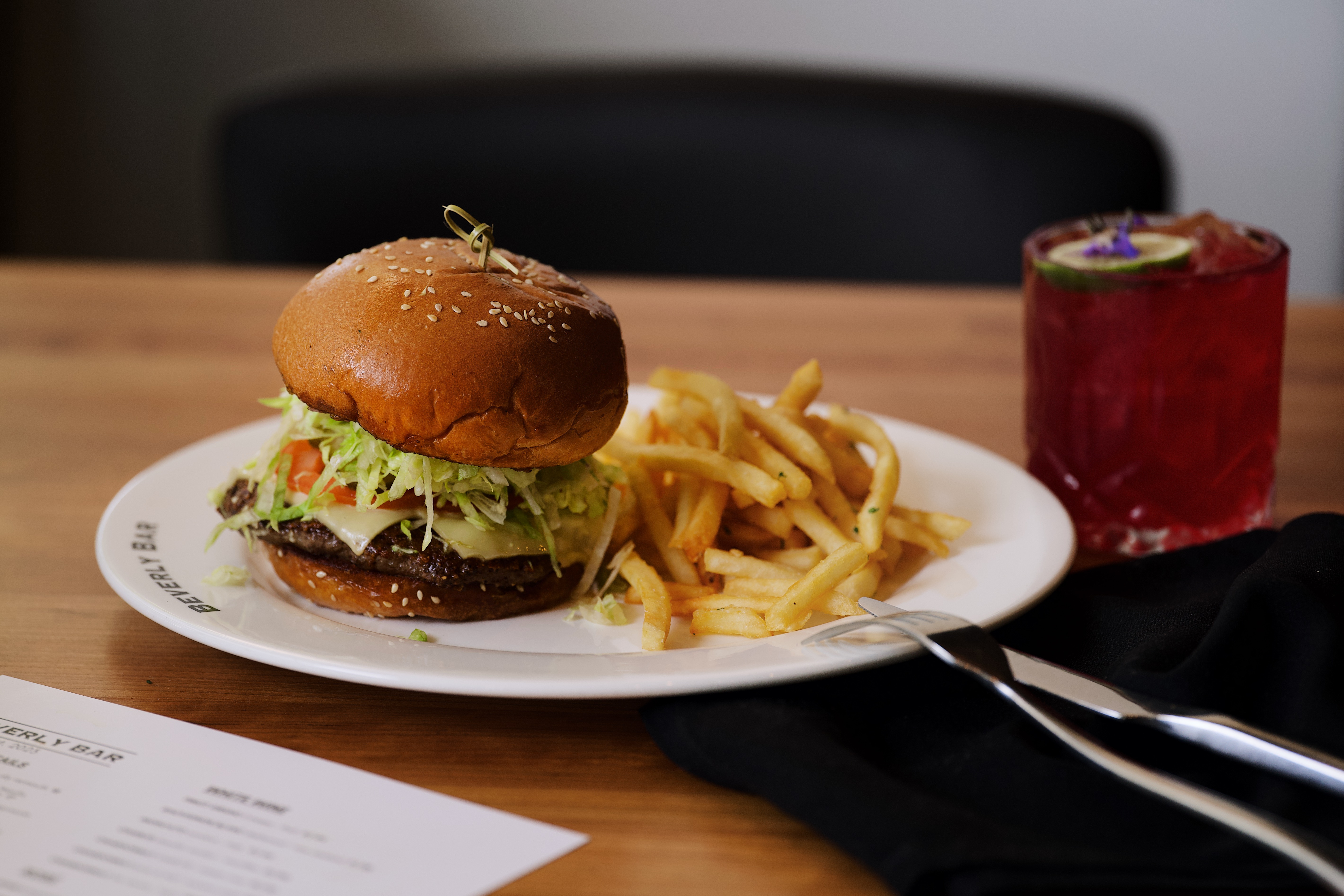 The Beverly Smash Burger with hand-cut fries and a signature cocktail